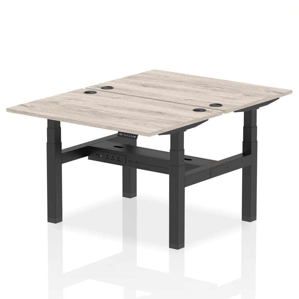 Back-to-back height adjustable desk with wood-effect top and metal frame on a white background