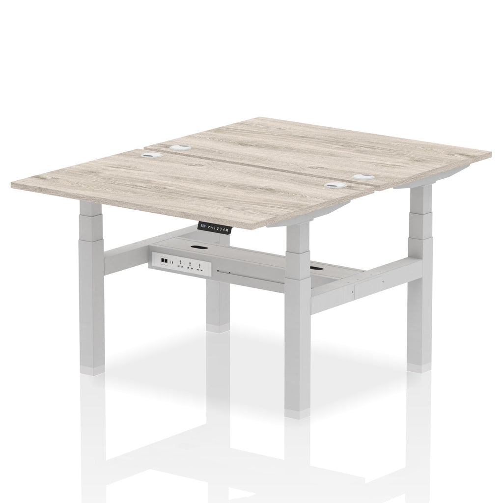 Back-to-back height adjustable desk with wood-effect top and metal frame on a white background