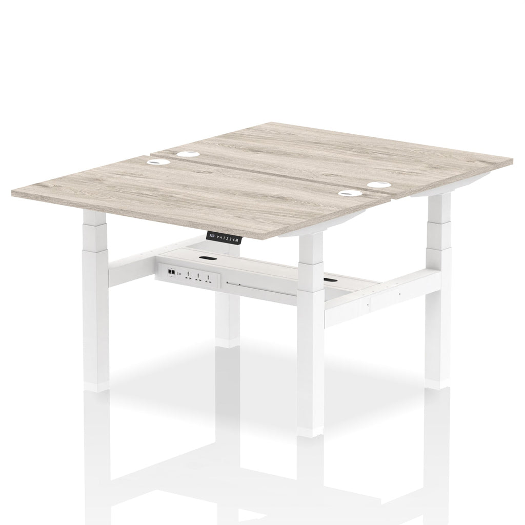 Back-to-back height adjustable desk with wood-effect top and metal frame on a white background