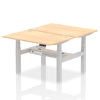 Back-to-back height adjustable desk with wood-effect top and metal frame on a white background