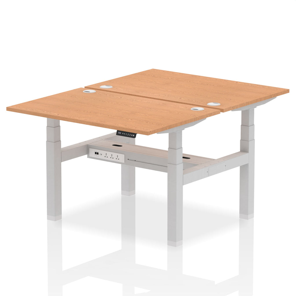 Back-to-back height adjustable desk with wood-effect top and metal frame on a white background