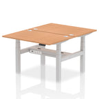 Back-to-back height adjustable desk with wood-effect top and metal frame on a white background