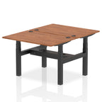 Back-to-back height adjustable desk with wood-effect top and metal frame on a white background