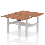 Back-to-back height adjustable desk with wood-effect top and metal frame on a white background