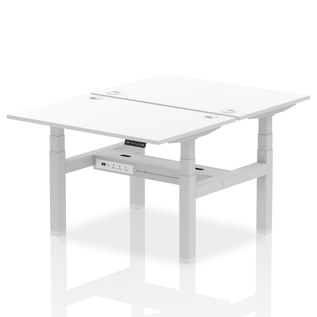Back-to-back height adjustable desk with white top and metal frame on a white background
