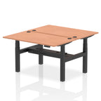 Back-to-back height adjustable desk with wood-effect top and metal frame on a white background