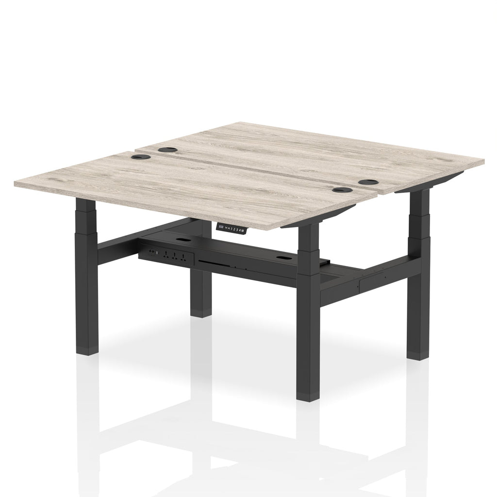Back-to-back height adjustable desk with wood-effect top and metal frame on a white background