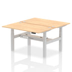 Back-to-back height adjustable desk with wood-effect top and metal frame on a white background
