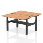 Back-to-back height adjustable desk with wood-effect top and metal frame on a white background