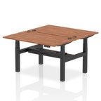 Back-to-back height adjustable desk with wood-effect top and metal frame on a white background