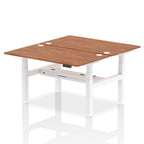 Back-to-back height adjustable desk with wood-effect top and metal frame on a white background