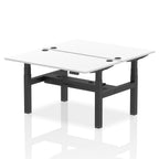 Back-to-back height adjustable desk with white top and metal frame on a white background