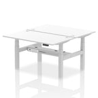 Back-to-back height adjustable desk with white top and metal frame on a white background