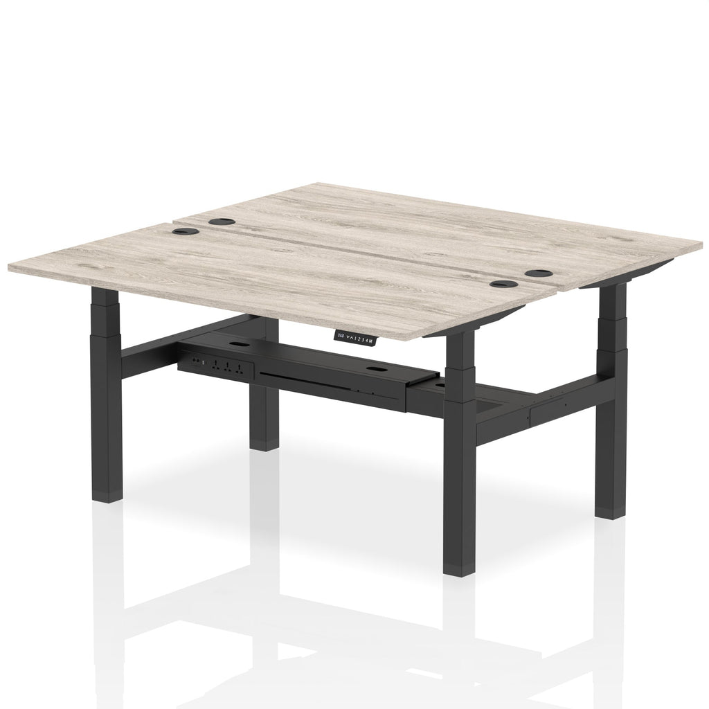 Back-to-back height adjustable desk with wood-effect top and metal frame on a white background