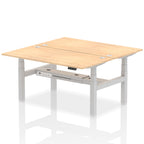 Back-to-back height adjustable desk with wood-effect top and metal frame on a white background