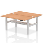 Back-to-back height adjustable desk with wood-effect top and metal frame on a white background