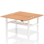 Back-to-back height adjustable desk with wood-effect top and metal frame on a white background