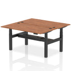 Back-to-back height adjustable desk with wood-effect top and metal frame on a white background
