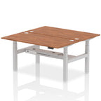 Back-to-back height adjustable desk with wood-effect top and metal frame on a white background