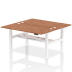 Back-to-back height adjustable desk with wood-effect top and metal frame on a white background