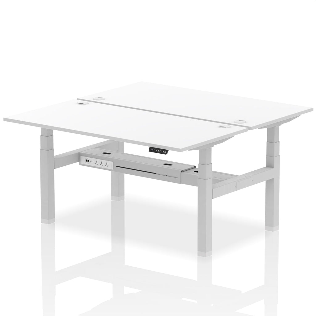 Back-to-back height adjustable desk with white top and metal frame on a white background
