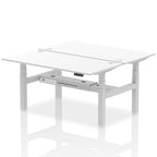 Back-to-back height adjustable desk with white top and metal frame on a white background