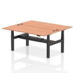 Back-to-back height adjustable desk with wood-effect top and metal frame on a white background