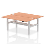 Back-to-back height adjustable desk with wood-effect top and metal frame on a white background