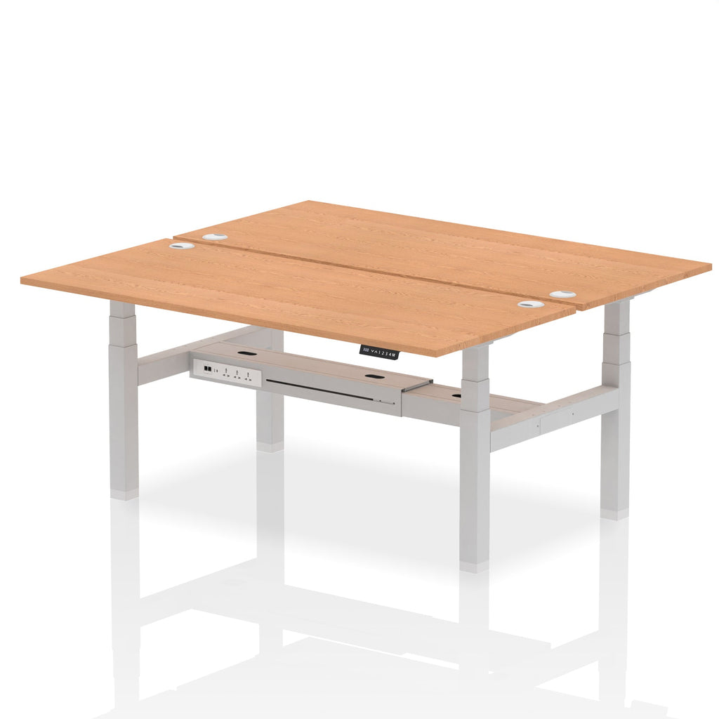 Back-to-back height adjustable desk with wood-effect top and metal frame on a white background