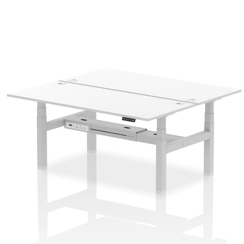 Back-to-back height adjustable desk with white top and metal frame on a white background