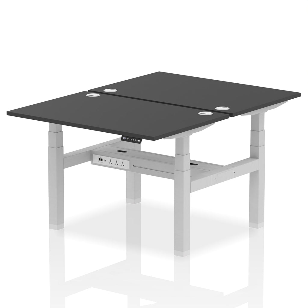 Back-to-back height adjustable desk with black top and metal frame on a white background
