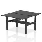 Back-to-back height adjustable desk with black top and metal frame on a white background