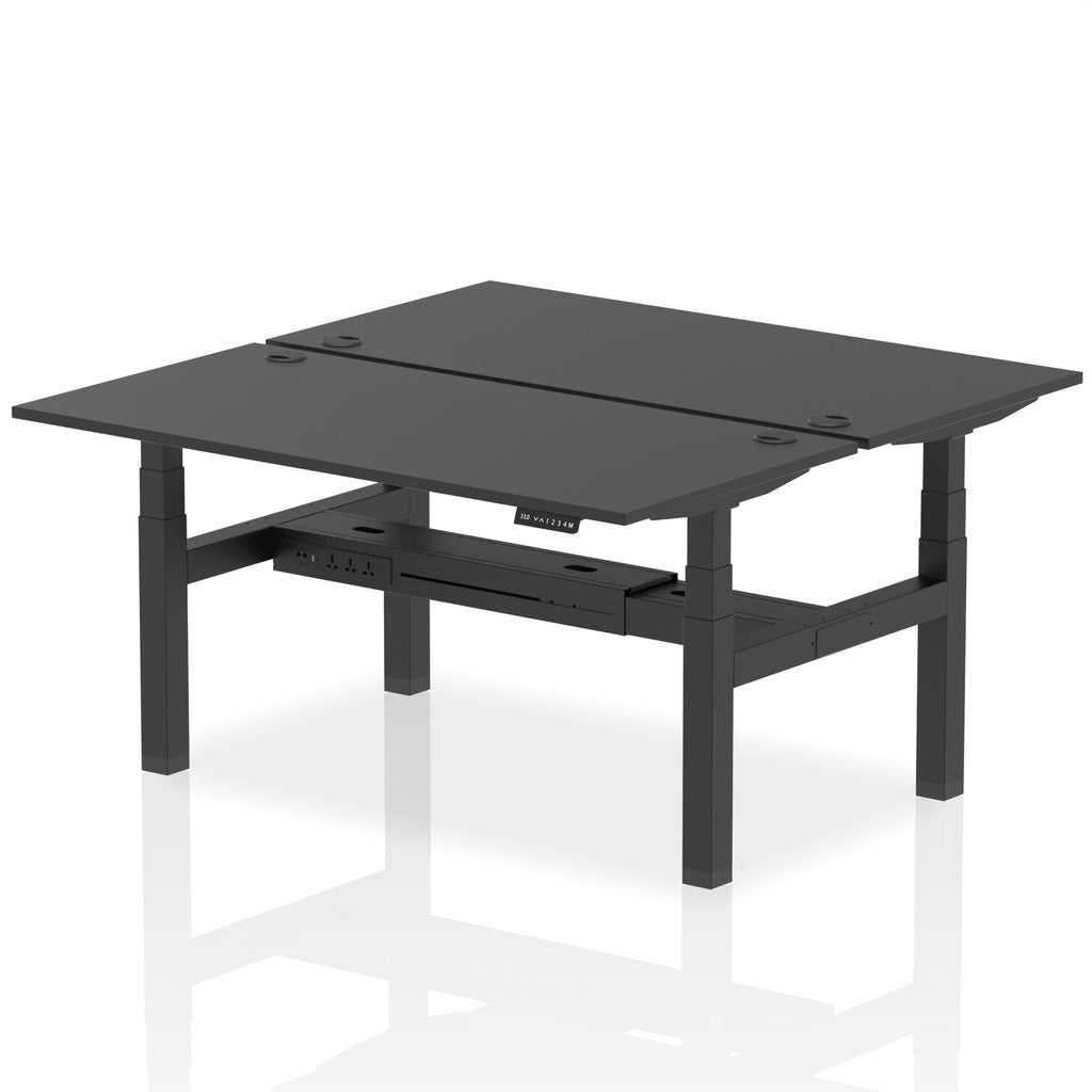Back-to-back height adjustable desk with black top and metal frame on a white background