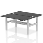 Back-to-back height adjustable desk with black top and metal frame on a white background