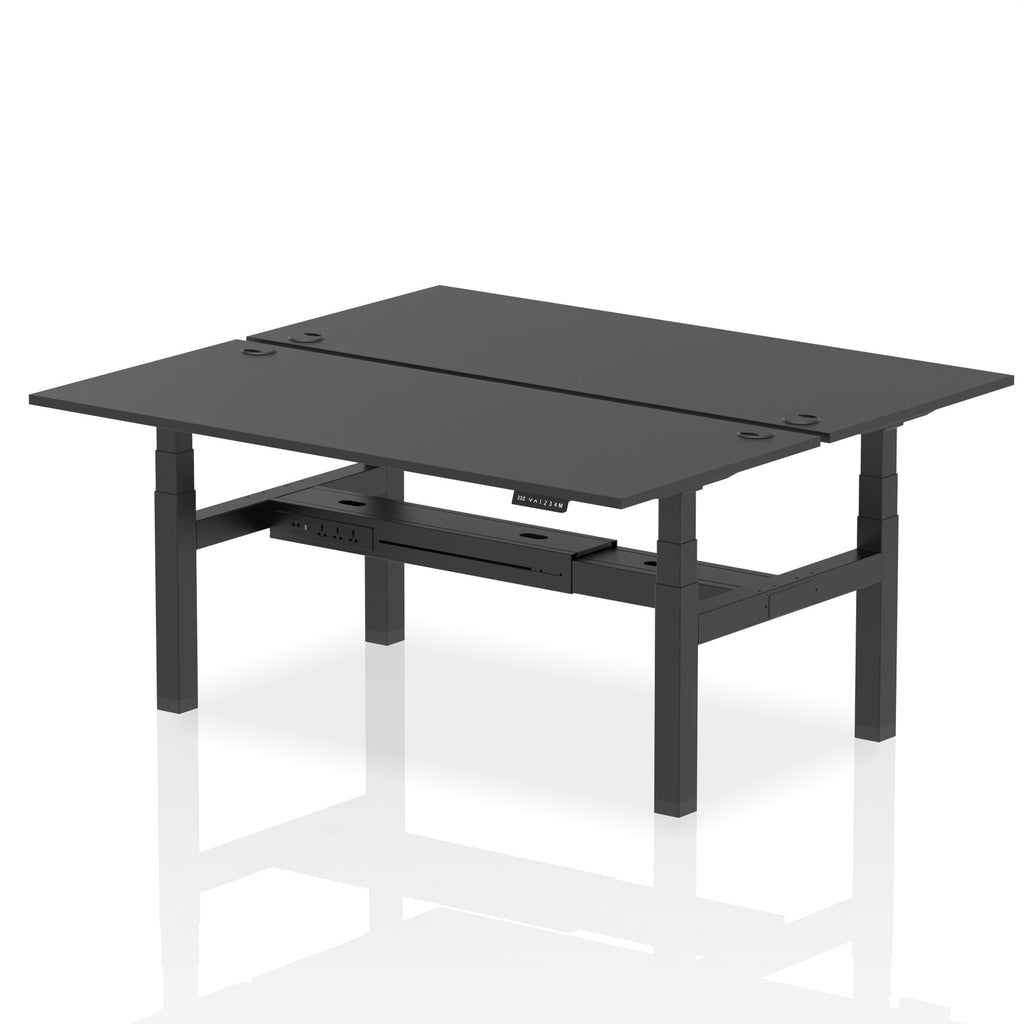 Back-to-back height adjustable desk with black top and metal frame on a white background