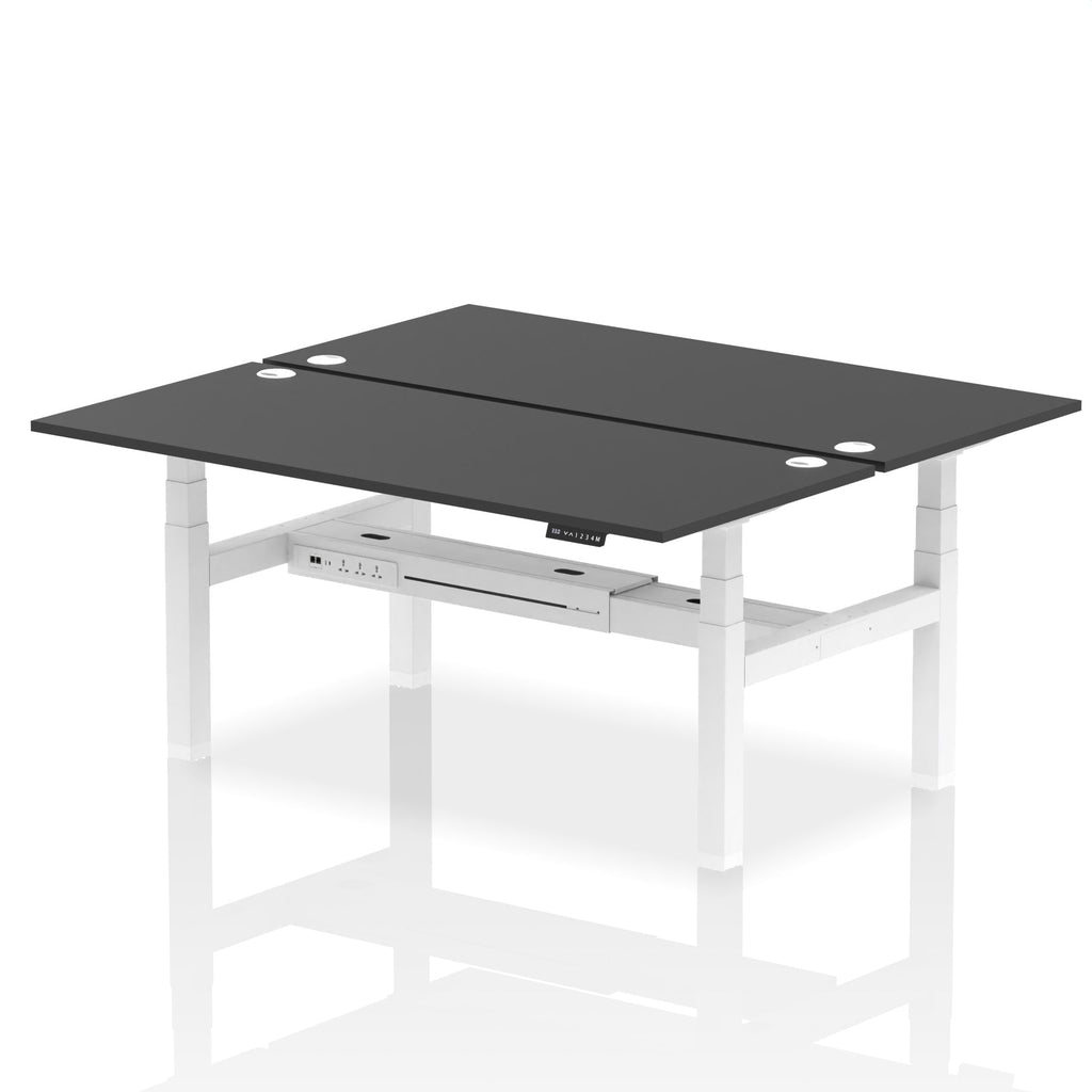 Back-to-back height adjustable desk with black top and metal frame on a white background