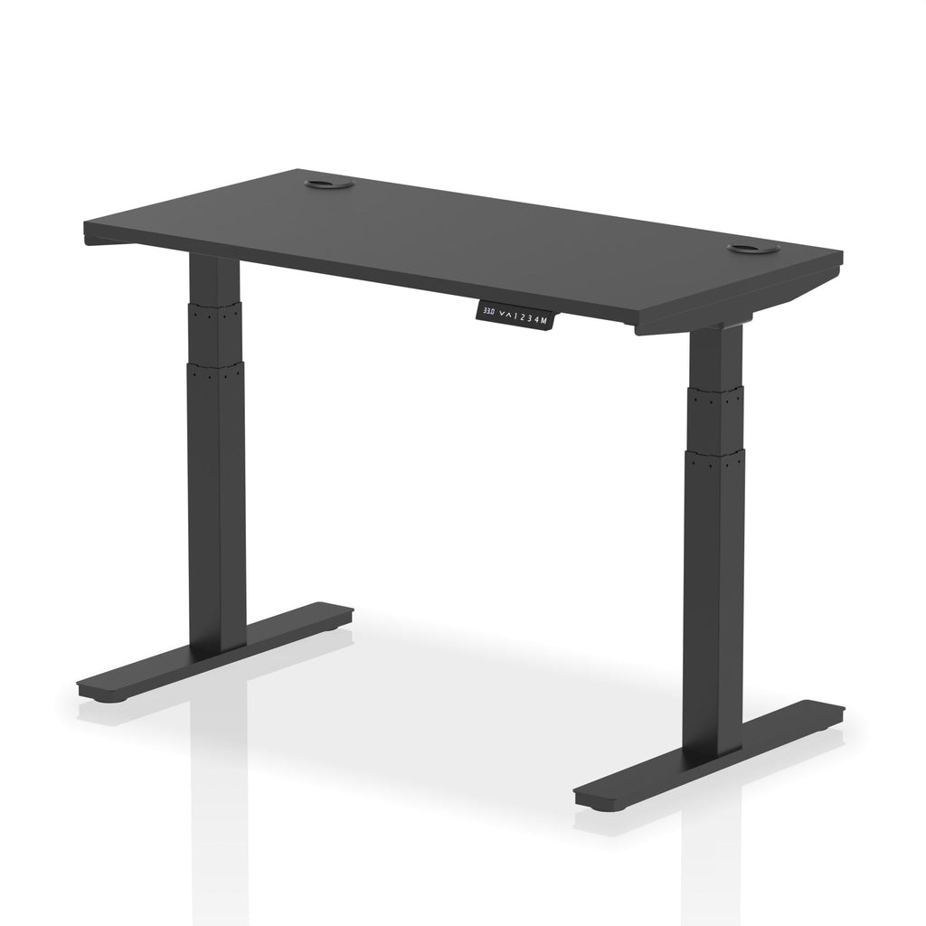 Adjustable height desk with black top and metal legs on a white background