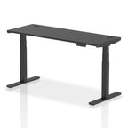 Adjustable height desk with black top and metal legs on a white background