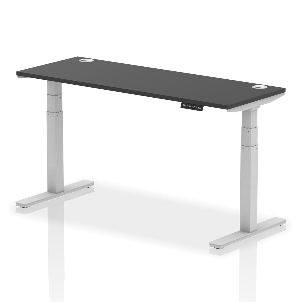 Adjustable height desk with black top and metal legs on a white background