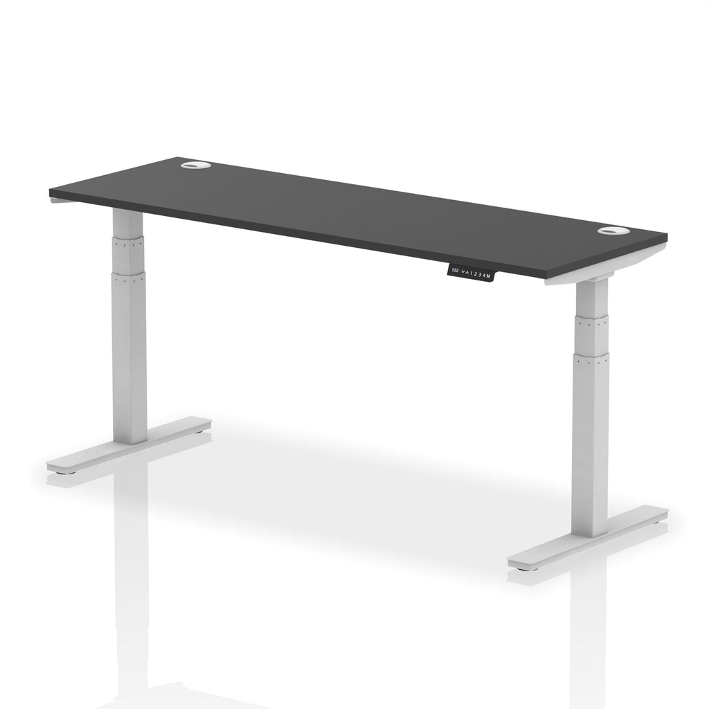 Adjustable height desk with black top and metal legs on a white background