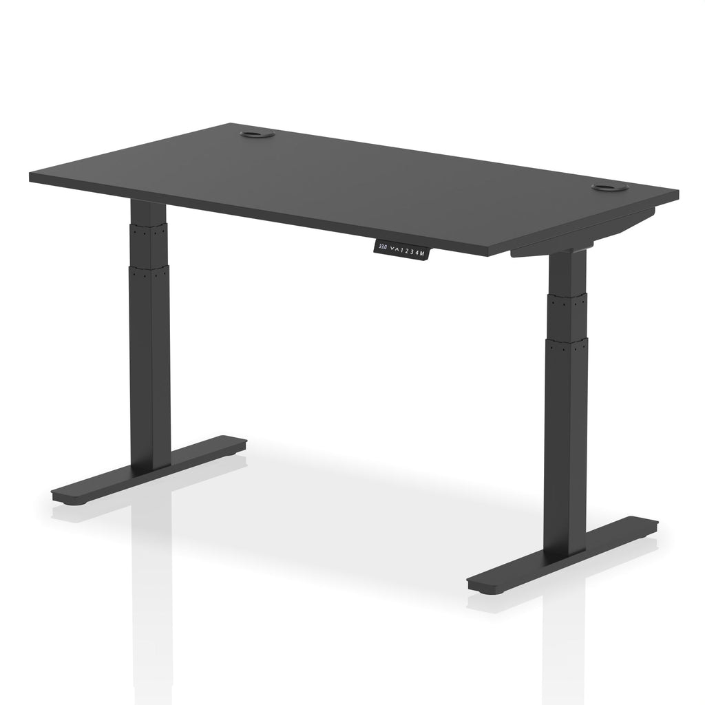 Adjustable height desk with black top and metal legs on a white background