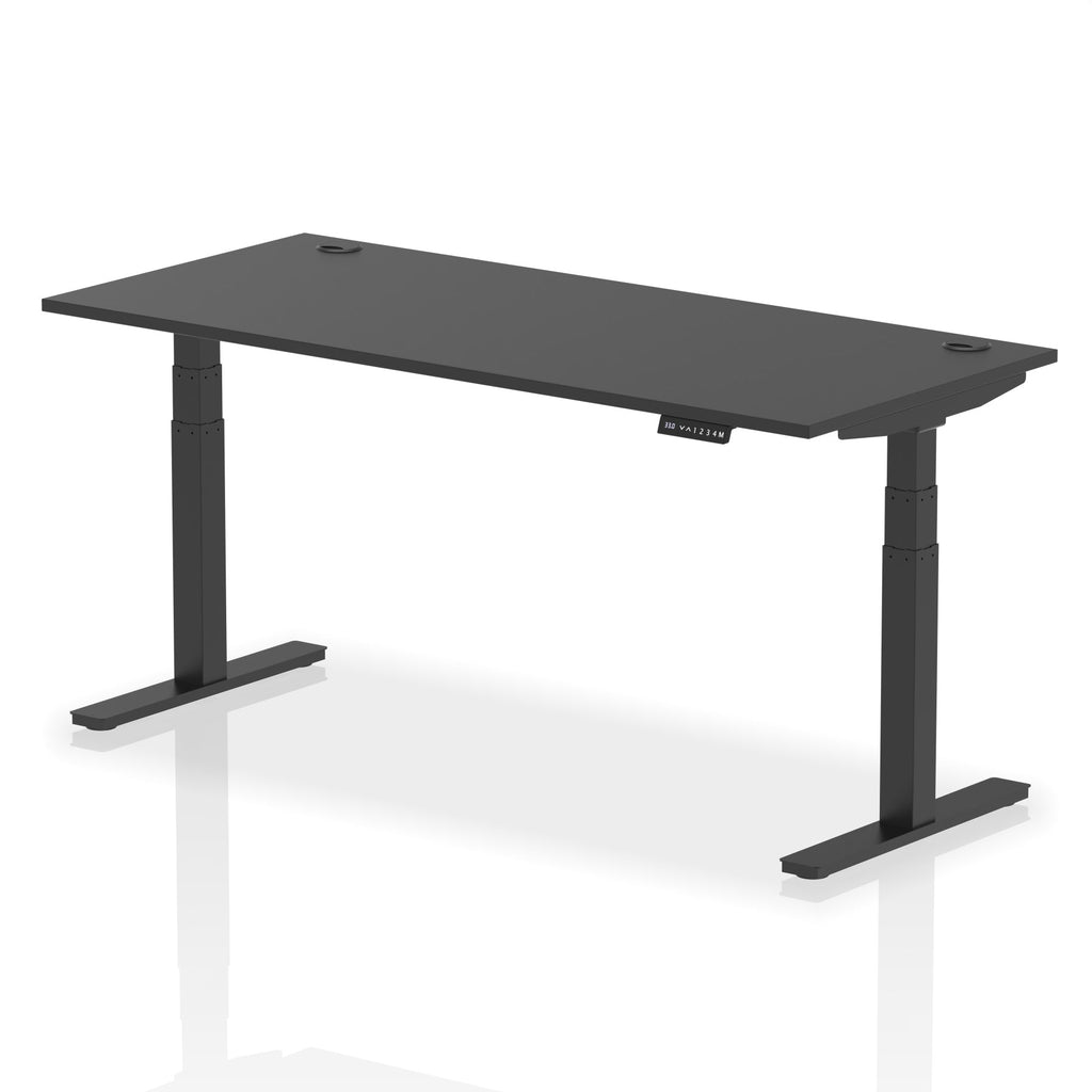 Adjustable height desk with black top and metal legs on a white background