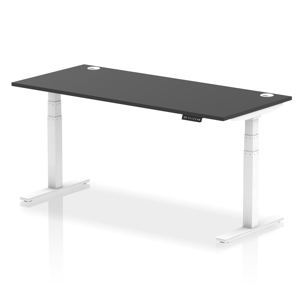 Adjustable height desk with black top and metal legs on a white background