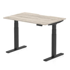 Height adjustable desk with wood-effect top and black frame on a white background