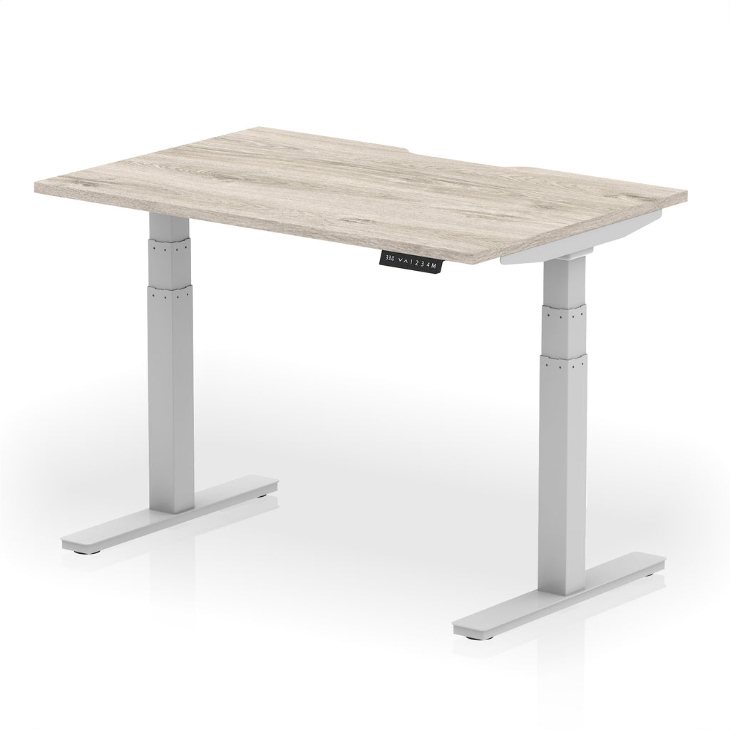 Height adjustable desk with wood-effect top and silver frame on a white background