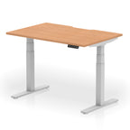 Height adjustable desk with wood-effect top and silver frame on a white background