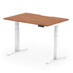 Height adjustable desk with wood-effect top and white frame on a white background
