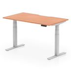 Height adjustable desk with wood-effect top and silver frame on a white background