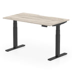 Height adjustable desk with wood-effect top and black frame on a white background
