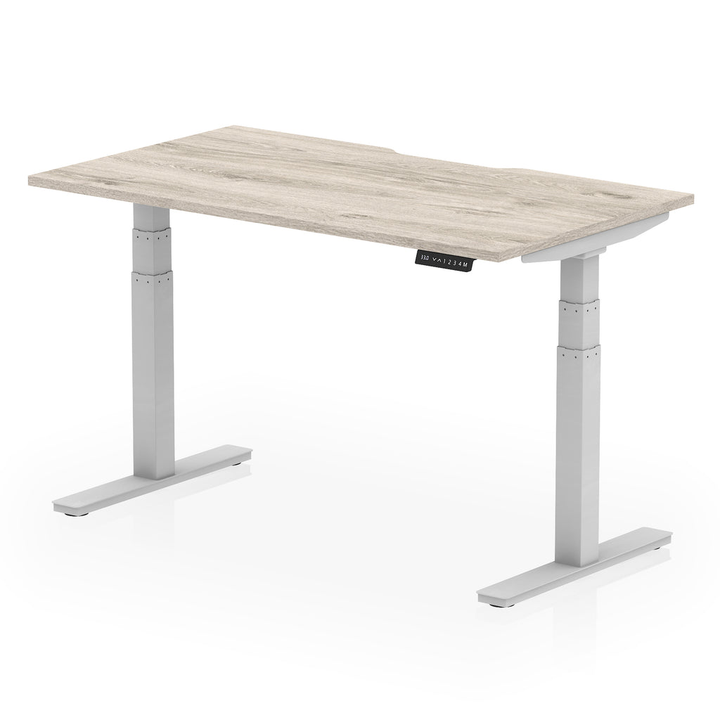 Height adjustable desk with wood-effect top and silver frame on a white background